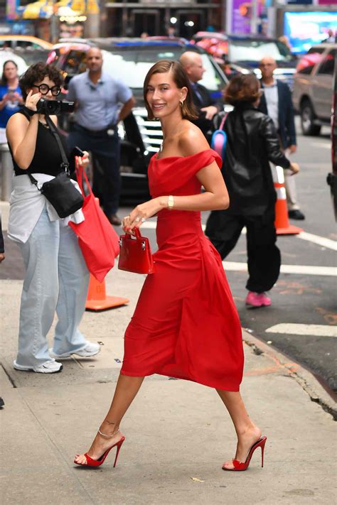 Hailey Bieber S Red Hot Monochromatic Look Featured An Off The Shoulder Dress And Matching Stilettos