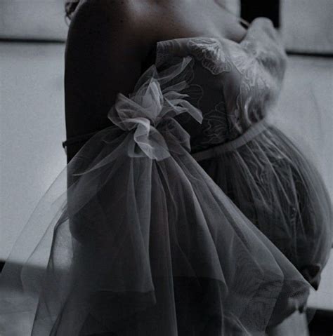 Black And White Photograph Of A Pregnant Woman Wearing A Tulle Skirt