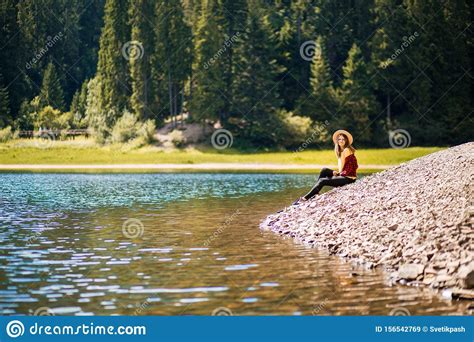 Tourist Woman In Straw Hat Rest Near Turquoise Blue Lake And Scenic