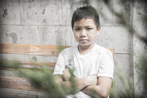 Young Asian Boy Sitting Alone In The Park Stock Image Image Of