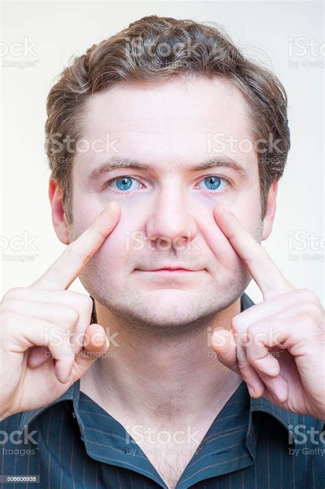 Portrait Of Man Points On His Eyes Human Face Parts Stock Photo