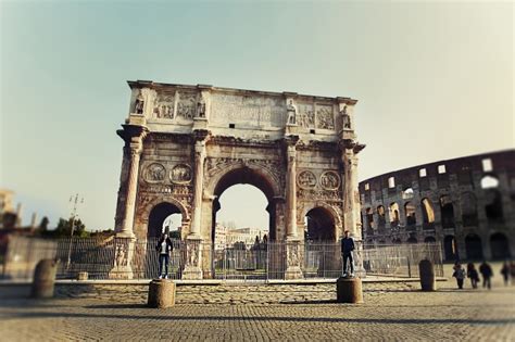 Two People Standing On The Colums Near Arch Of Constantine