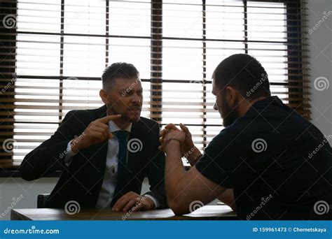 Angry Detective Interviewing Criminal In Room Stock Image Image Of
