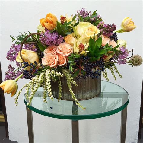 A Vase Filled With Flowers Sitting On Top Of A Glass Table