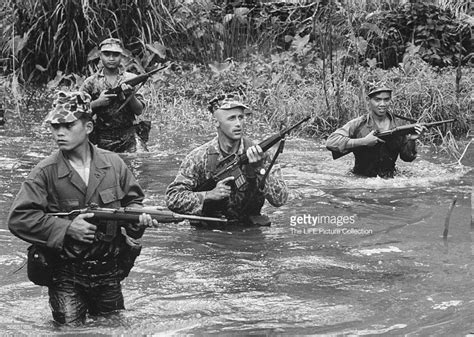 Patrol Of Montagnard Soldiers Wading Through Jungle Stream Led By Us
