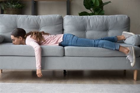 Young Woman Lying Buried Her Face In Sofa Feels Tired Dnq Solutions Llc
