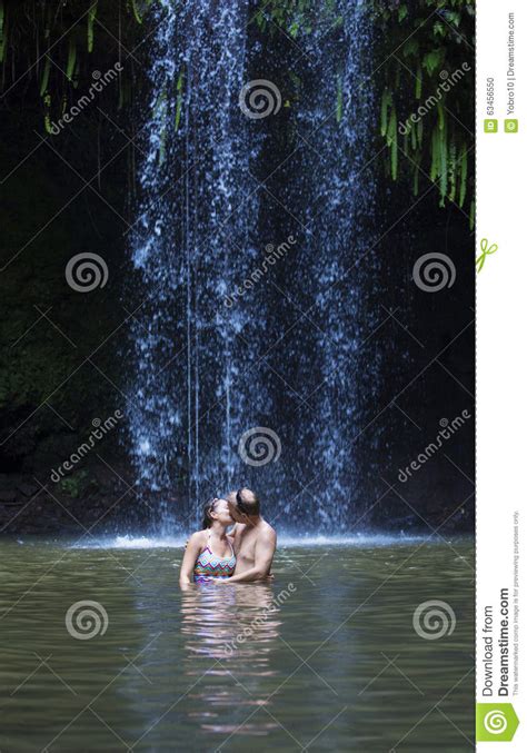 Couple Kissing Under A Beautiful Tropical Waterfall Stock Photo Image