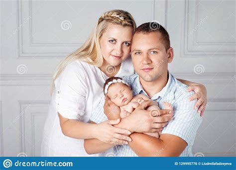 Happy Parents Holding A Cute Newborn Girl Mom Dad And Baby Stock