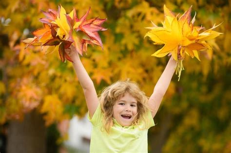 Premium Photo Kids Play With Autumn Fall Leaves In Park Children
