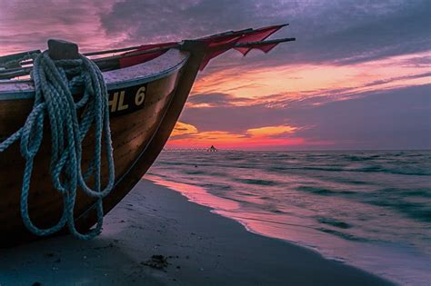 Brown Wooden Boat On Shore During Sunset · Free Stock Photo