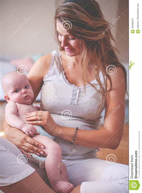 Mother And Her Cute Baby At Home Mother Holding Little