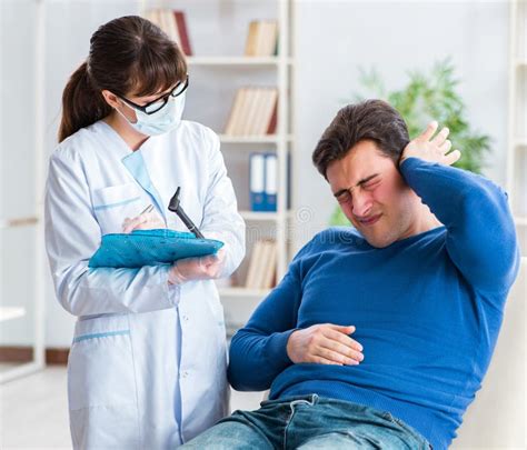 Doctor Checking Patients Ear During Medical Examination Stock Image