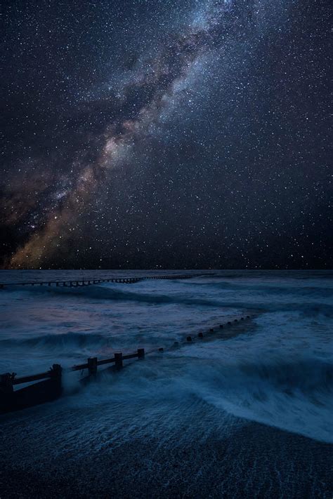 Vibrant Milky Way Composite Image Over Landscape Of Waves Crashi