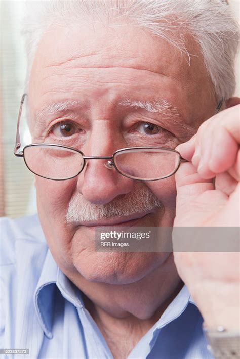 Senior Man Looking Over Glasses High Res Stock Photo Getty Images