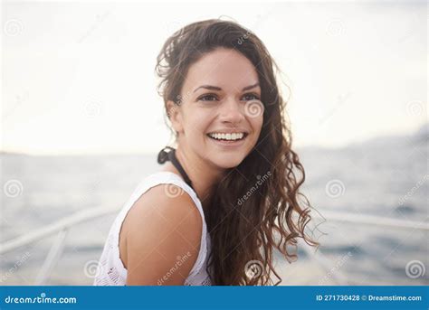 Enjoying A Summer Sail Portrait Of An Attractive Young Woman Enjoying A Boat Ride On The Lake