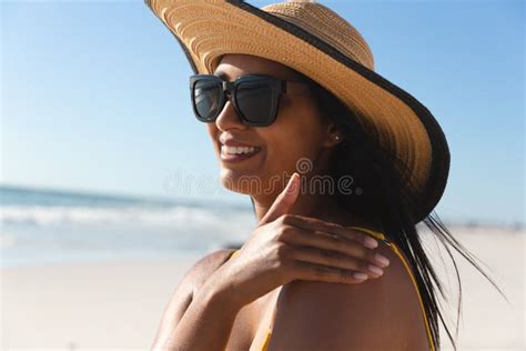 Smiling Mixed Race Woman On Beach Holiday Using Sunscreen Cream Stock Photo Image Of Coast