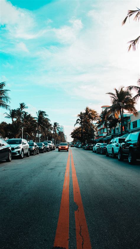 Download Wallpaper 2160x3840 Road Cars Markings Palm Trees Sky