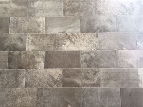 A Tile Floor With Different Shades Of Gray And White Tiles On The Top