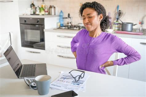 Tired Black Woman Working From Home Suffering Backache Stock Photo