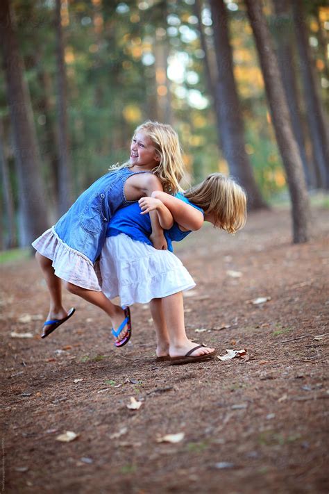 Sisters Linking Arms And Playing By Stocksy Contributor Dina Marie Giangregorio Stocksy
