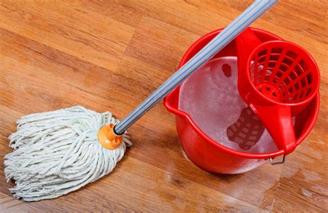 Cleaning Of Wet Floors By Mop And Red Bucket With Washing Water