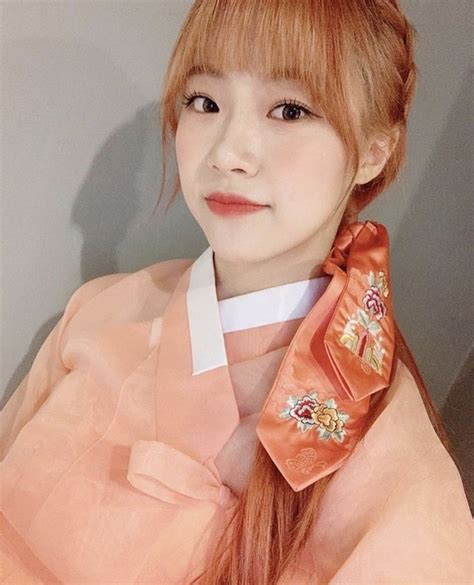 A Woman With Long Red Hair Wearing An Orange Kimono
