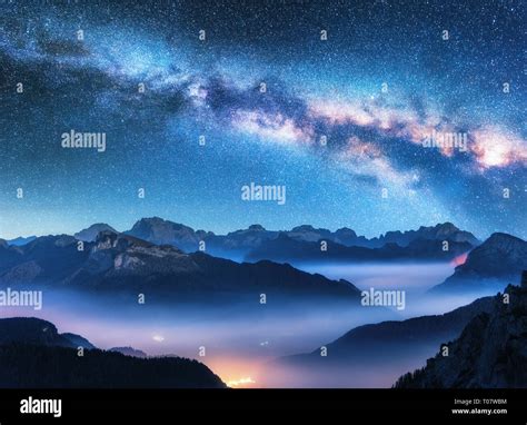 Milky Way Above Mountains In Fog At Night In Summer Landscape With