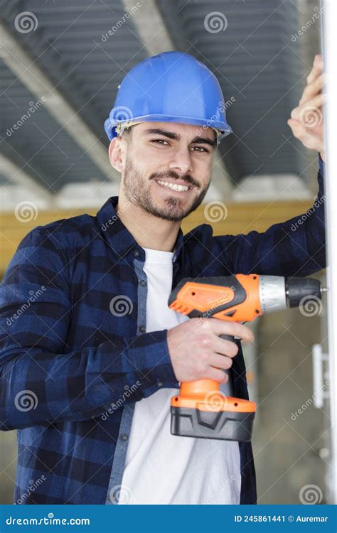 Portrait Young Male Builder Using Cordless Screwdriver Stock Image