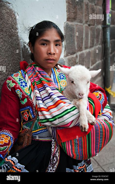 Peruvian Woman In Traditional Costume Holding Her Lamb In Cusco Peru