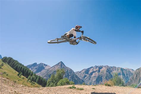 Man Performing Midair Stunts With Mountain Bike By Stocksy