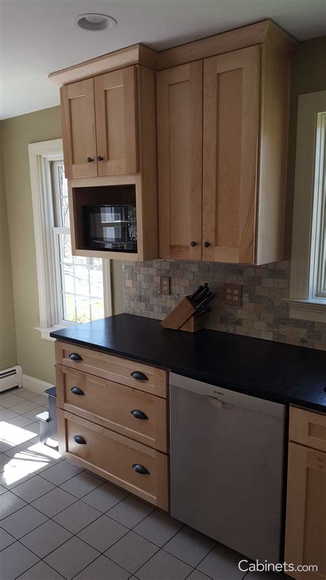 Small Shaker Kitchen With Natural Stained Cabinets And Black
