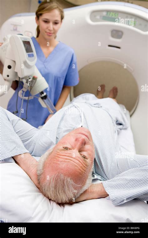 Nurse With Patient As They Prepare For A Computerized Axial Tomography
