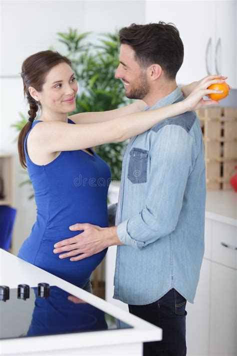 Husband Hugs Pregnant Wife In Kitchen Stock Image Image Of Relaxing Oxter 265339421