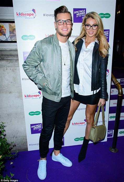 Two People Standing Next To Each Other On A Purple Carpet
