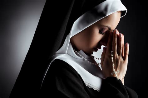Beautiful Young Nun With Closed Eyes Praying With Cross On Grey Free