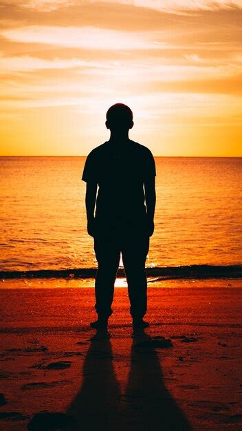 Premium Photo Silhouette Man Standing On Beach During Sunset