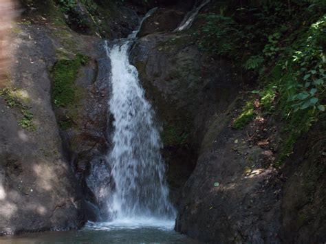 There Is A Waterfall In The Middle Of Some Rocks And Water Coming Out Of It