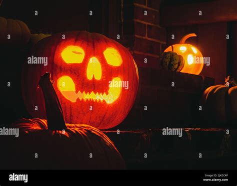Lighted Jack O Lanterns On A Doorstep On A Halloween Night Stock Photo