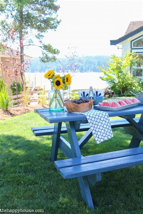 A Picnic Table With Sunflowers And Flowers On It