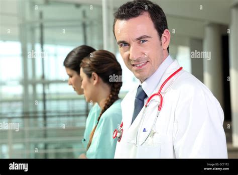 Doctor Standing With Two Nurses Stock Photo Alamy