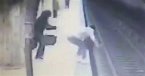 Woman Desperately Tries To Claw Her Way Back Onto Platform After Being Pushed In Front Of Train