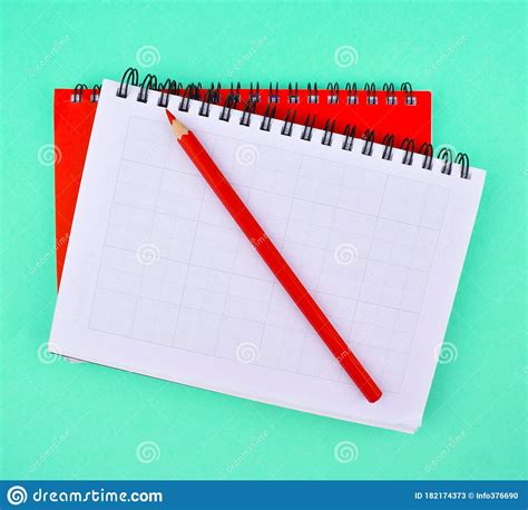 One Pencil Placed On Two Different Color Note Paper Diary Placed On Top Of Each Other On A Paper 