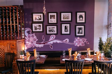 A Restaurant With Purple Walls And Pictures On The Wall