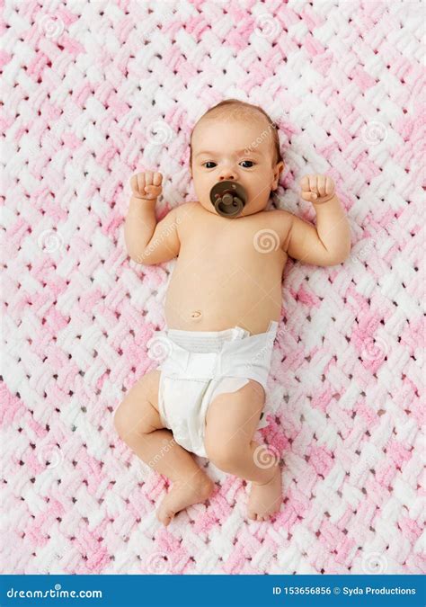 Baby Girl In Diaper Lying With Pacifier On Blanket Stock Photo Image