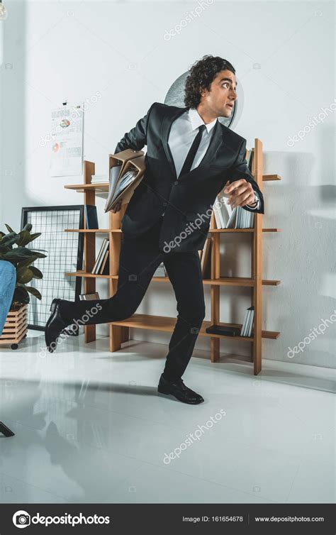 Businessman With Folders In Hurry — Stock Photo © Alexnazaruk 161654678