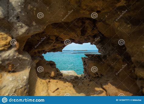 Sandstone Rock With Hole And Blue Sea In It Stock Image Image Of