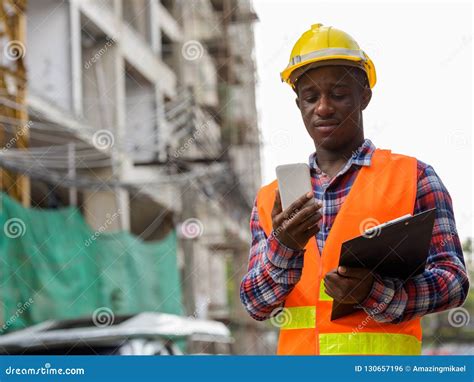 Young Black African Man Construction Worker Holding Clipboard Wh Stock