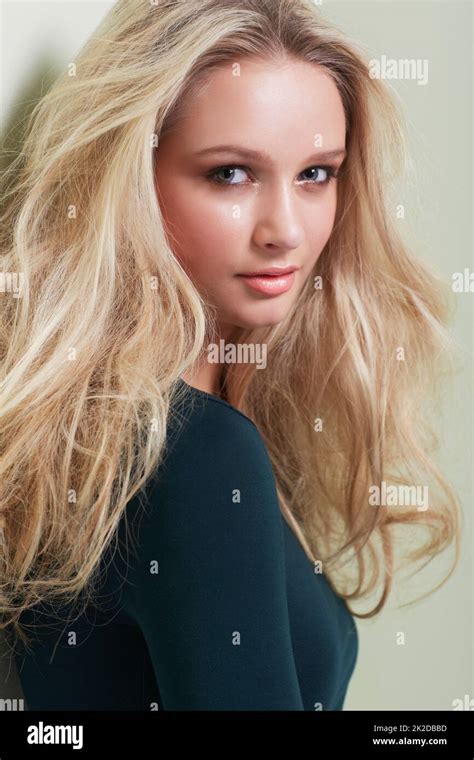 Her Beauty Is Magnetic Portrait Of A Gorgeous Young Model With Wild Blonde Hair Looking At You