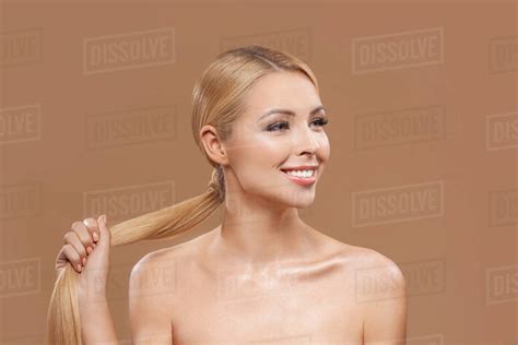 Smiling Naked Blonde Woman With Long Hair Isolated On Brown Haircare