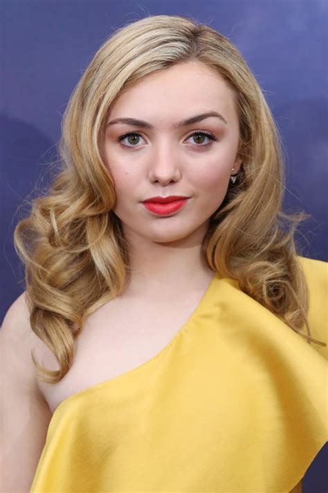 A Woman With Long Blonde Hair Wearing A Yellow Dress And Red Lipstick